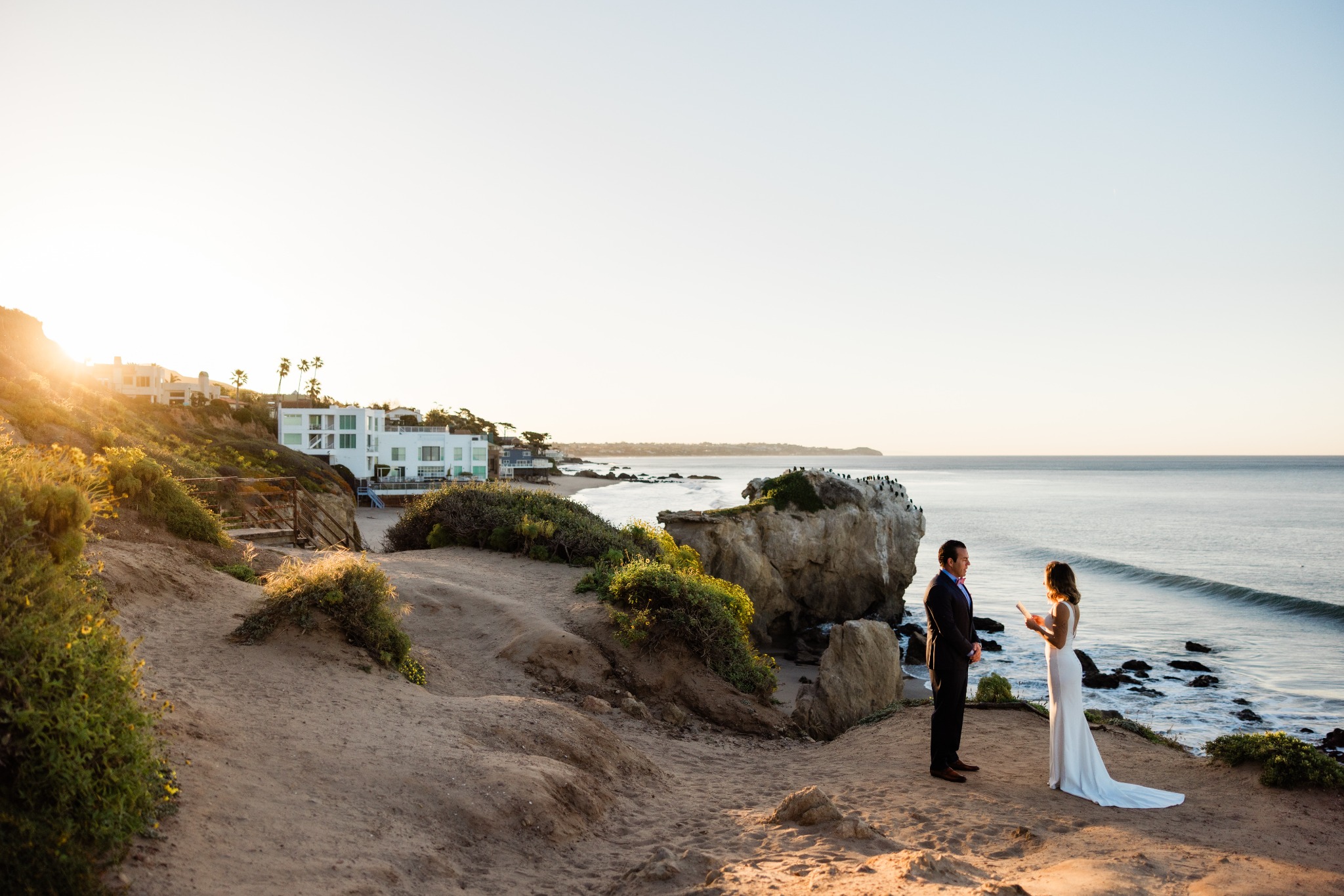 Sean and Mackaylee facing each other during their outdoor wedding ceremony